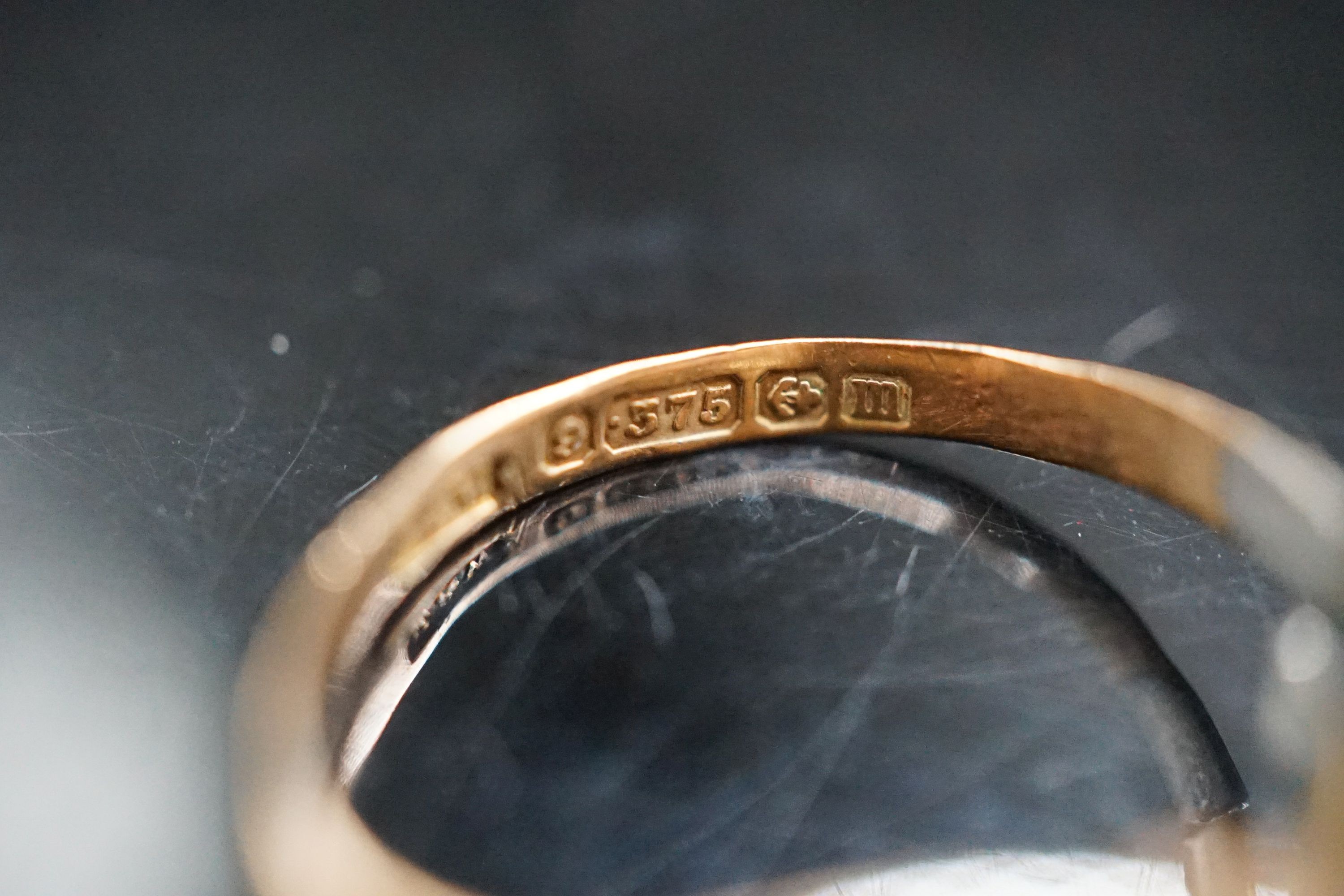 An 18ct gold wedding band, 2.1 grams and a 9ct gold signet ring (cut) 1.7 grams.